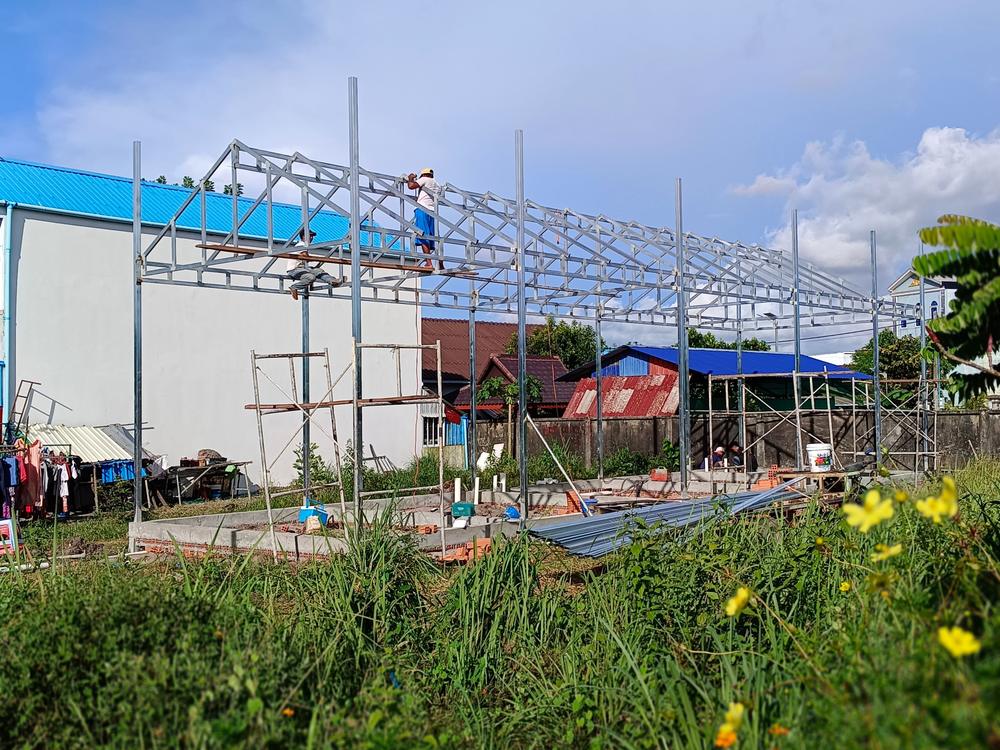 Steel roof trusses being erected over a new building