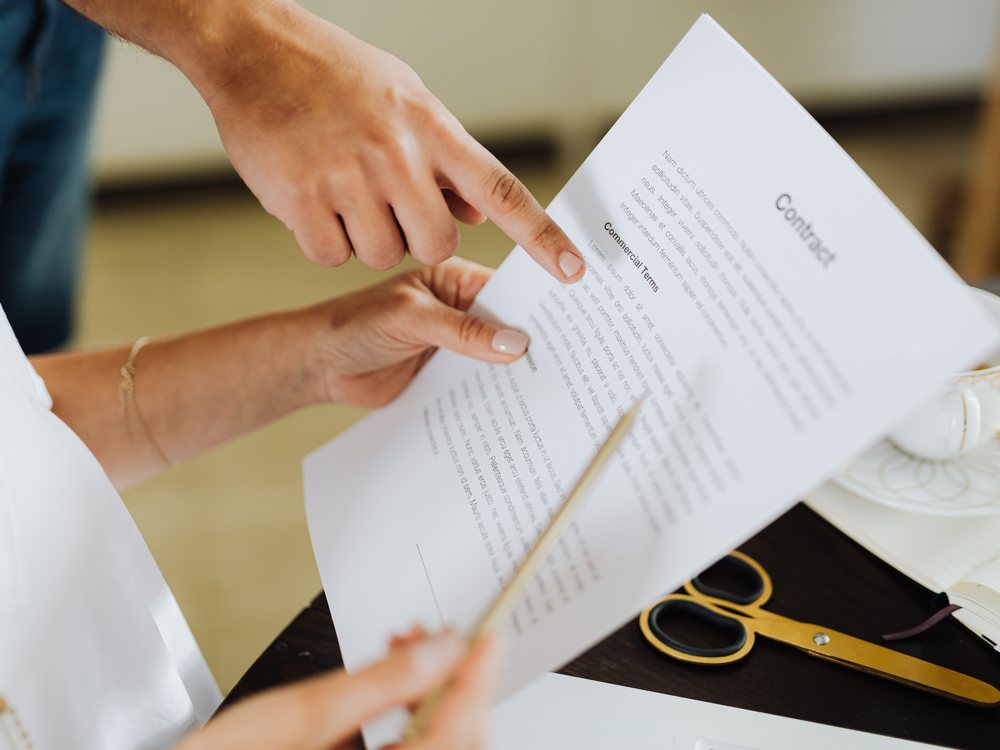 Two people reviewing the commercial terms of a contract