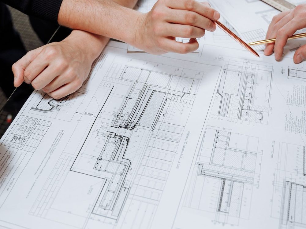 An architect working through a schematic drawing at a desk