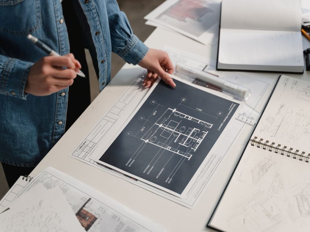 An engineer going through a set of technical drawings